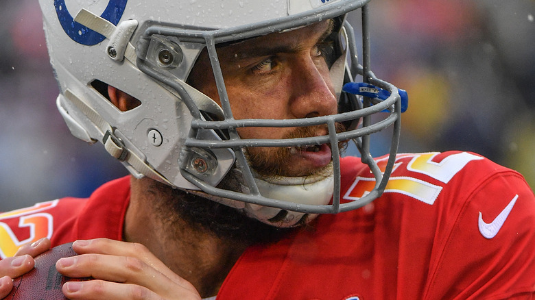 Andrew Luck helmet red jersey throwing football