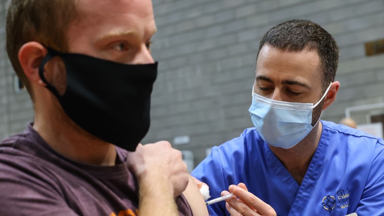 A Welshman receiving a covid shot in late 2021