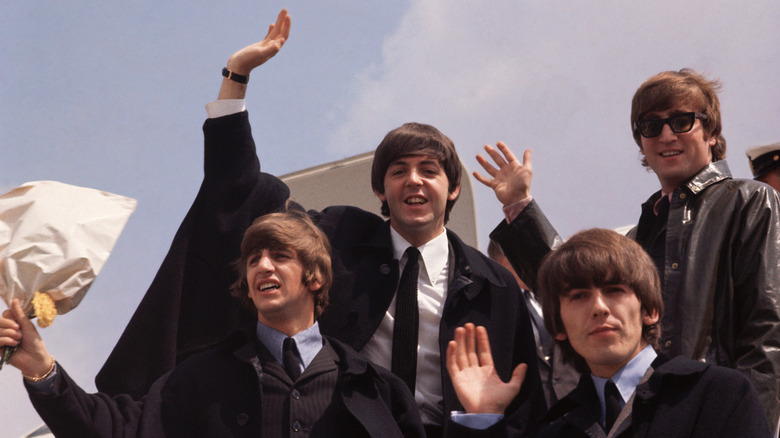 The Beatles stepping off a plane