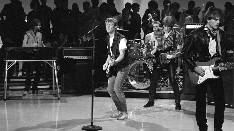 bryan adams on stage with his band