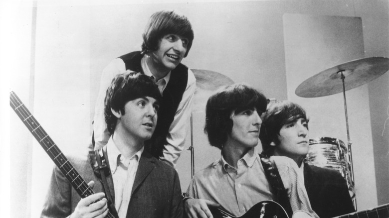 The Beatles in the 1960s posing with instruments