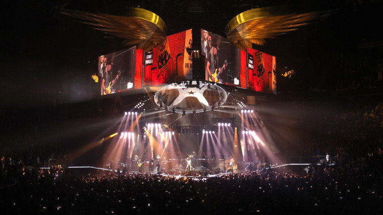 Rock fans raising hands at big concert