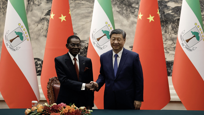 dictators of china and equatorial guinea shake hands at meeting