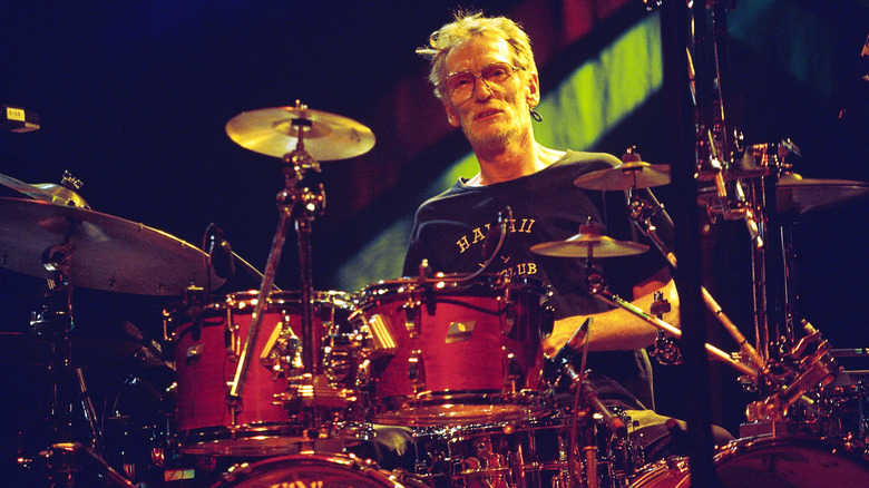 Ginger Baker playing the drum on stage