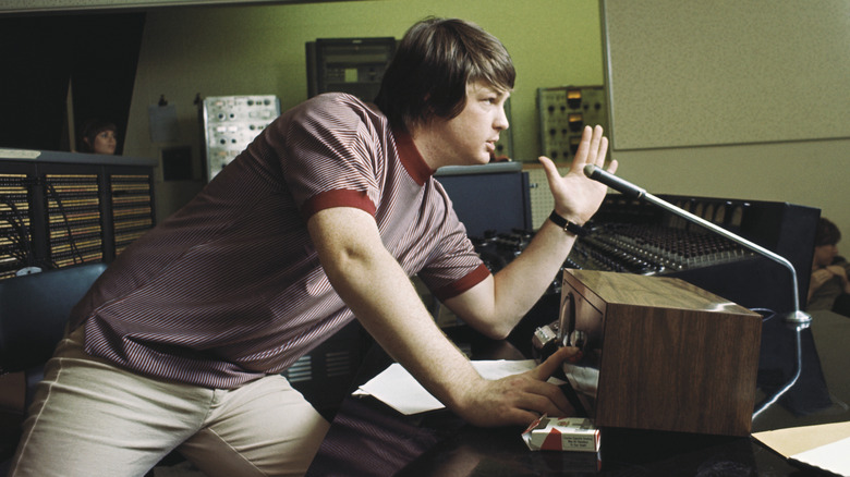 Brian Wilson leaning over mixing desk