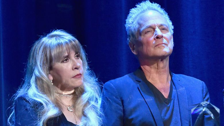 Stevie Nicks and Lindsey Buckingham lit in blue onstage