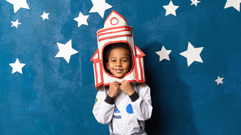 kid pretending to be a rocket astronaut