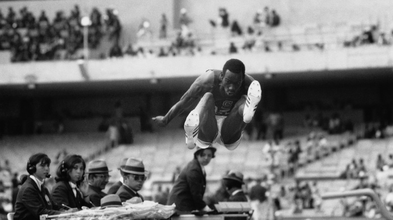 Bob Beamon setting an Olympic record in 1968