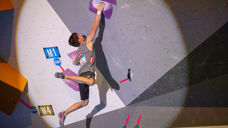 Nicolai Uznik hangs from handholds 