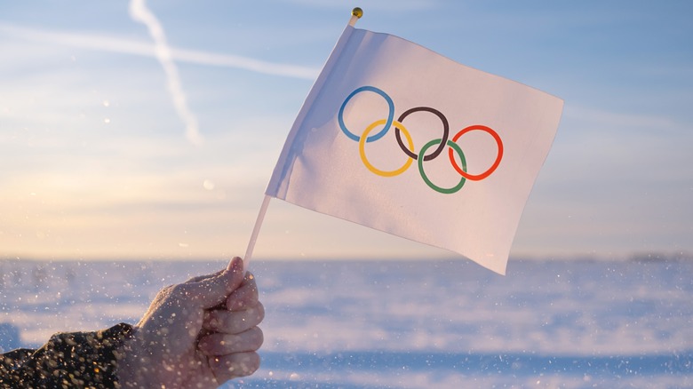 Hand holding Olympic flag