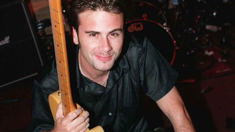 jamie walters holding a guitar in a 1990s publicity photo