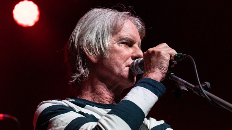 david fenton in striped sweater performing with the vapors