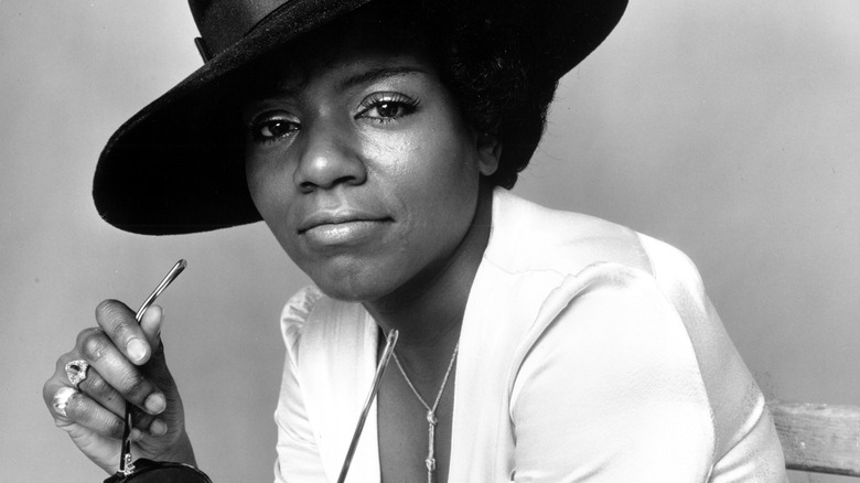 Gloria Gaynor poses for a photo holding sunglasses