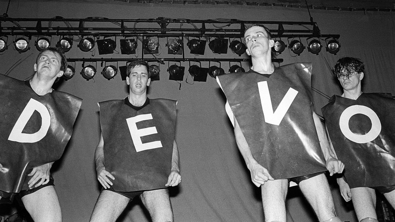 Devo stage wearing Devo shirts