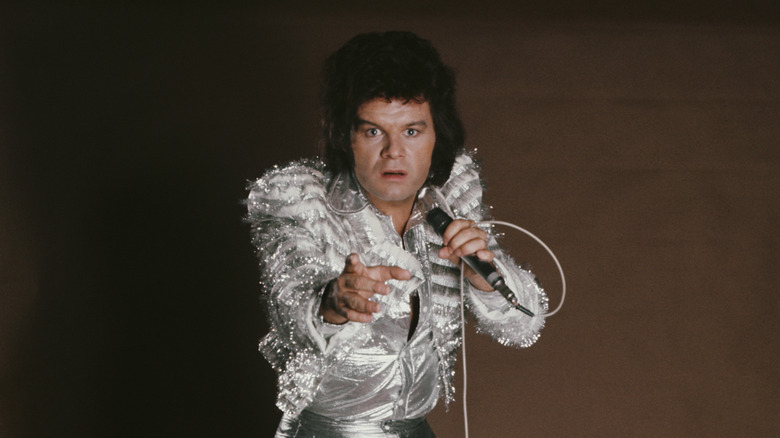 Gary Glitter posing with microphone
