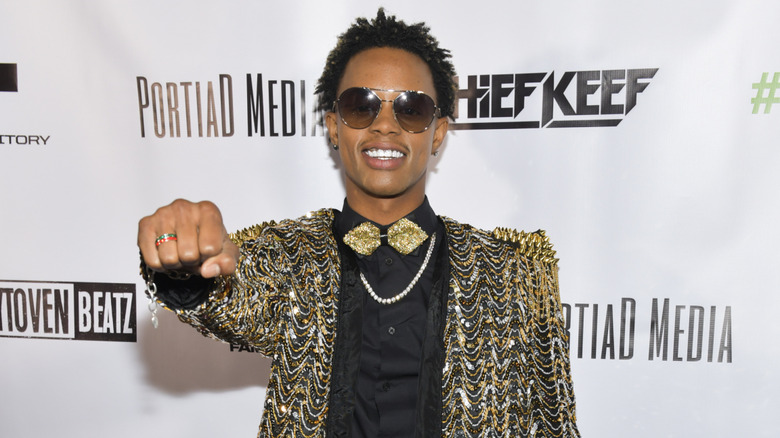 Silento raising his fist at an event