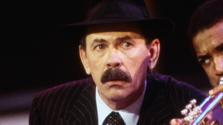 Scatman John looking concerned by a trumpet player