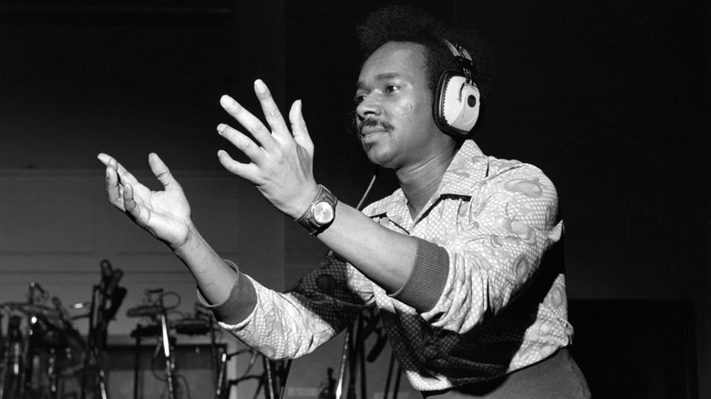 Van McCoy gesturing with hands headphones