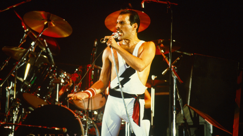 Freddie Mercury singing in front of Queen drums