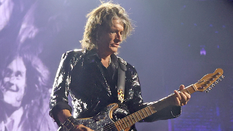 Joe Perry playing guitar on stage