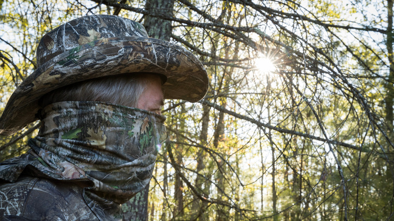 Man wearing camouflage in the woods