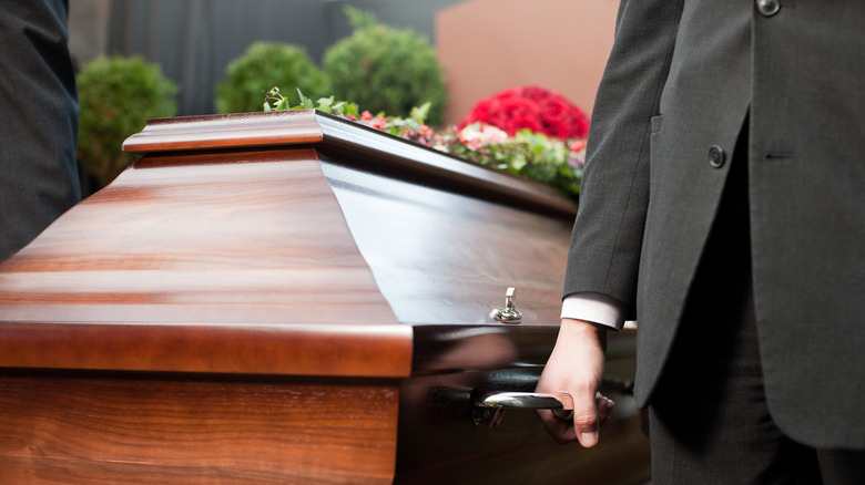 pallbearer holding a funeral casket
