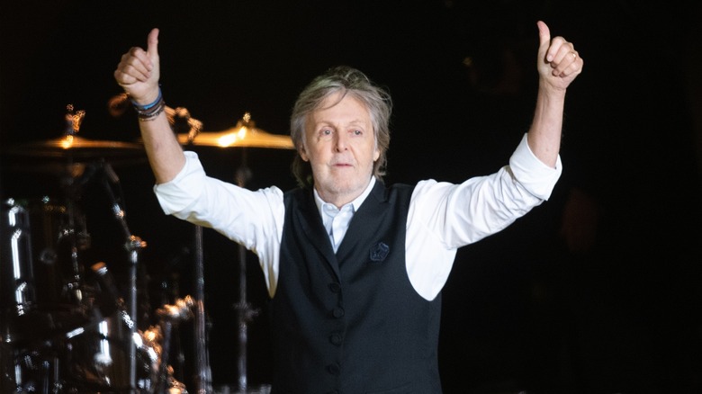 Paul McCartney doing thumbs-up onstage
