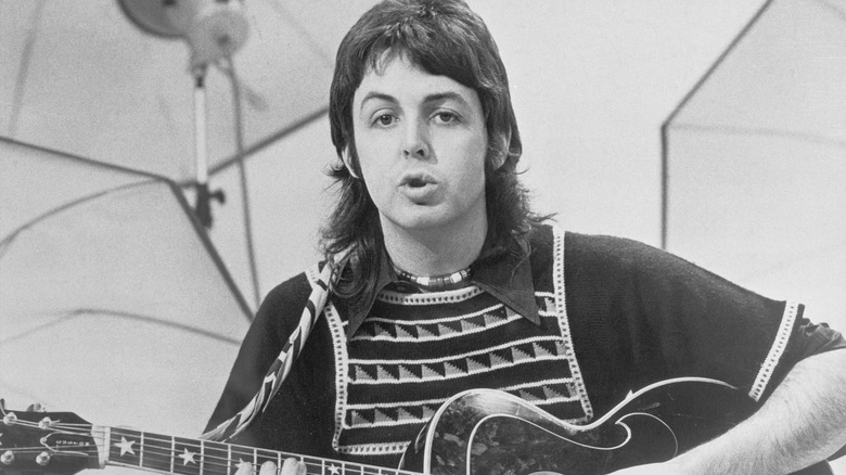 Paul McCartney gesturing in recording studio