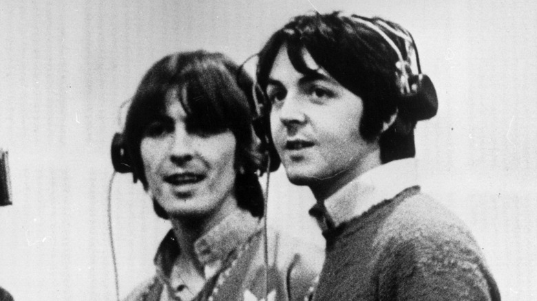 George Harrison and Paul McCartney in a recording studio