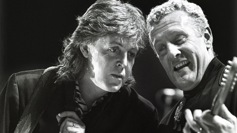 Paul McCartney performing with Hamish Stuart