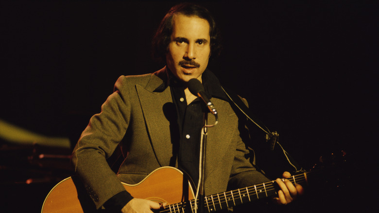 Paul Simon performing in London in 1975