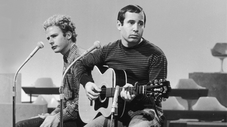 Paul Simon and Art Garfunkel on a stage looking forlorn