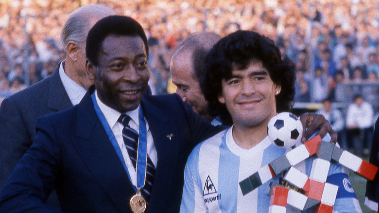 pele and diego maradona smiling