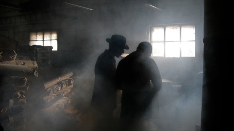 two men standing in smoke