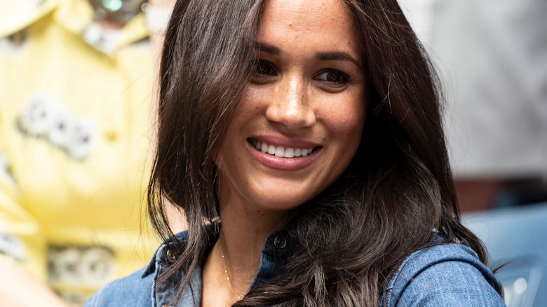 Meghan Markle smiling at tennis match