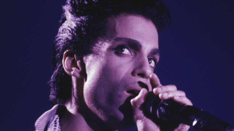 Prince looking sideways on stage