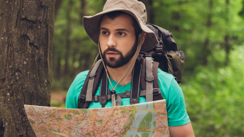 confused man, map, woods