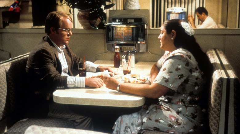 Philip Seymour Hoffman sitting at a restaurant movie Happiness