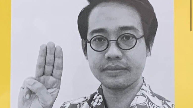 Wanchalearm Satsaksit holding up three finger sign 