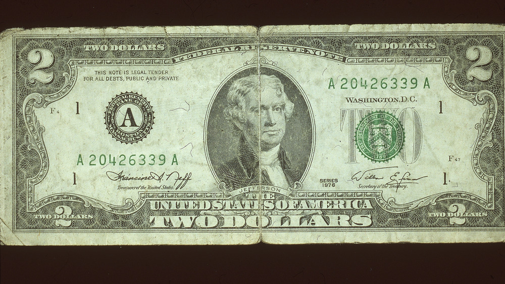 The image of Thomas Jefferson on a tattered $2 bill