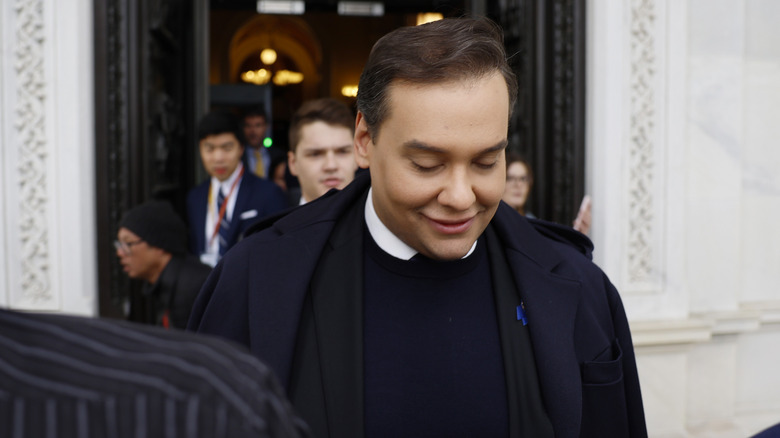 George Santos looking down while leaving Capitol Hill