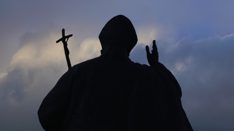 Silhouette of man with cross