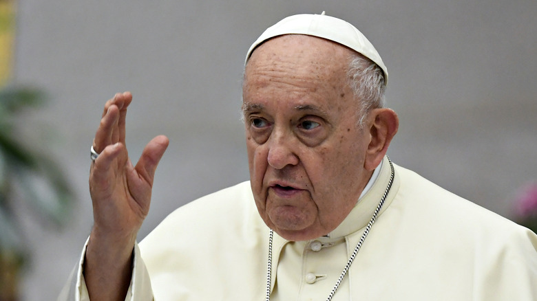 Pope Francis with hand raised