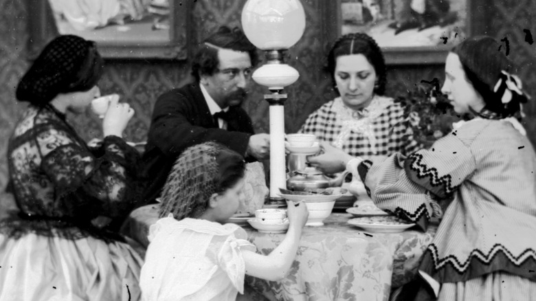 Family eating dinner in 1865
