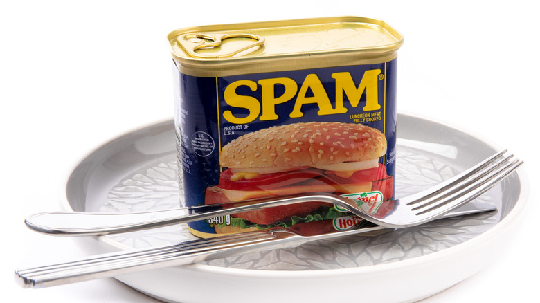 spam on a plate with a knife and fork