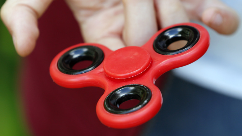 hand holding out fidget spinner