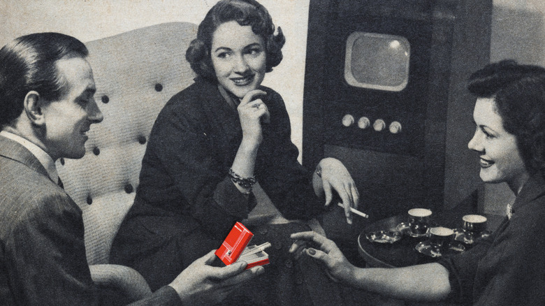 Print ad for cigarettes depicting people and a TV set