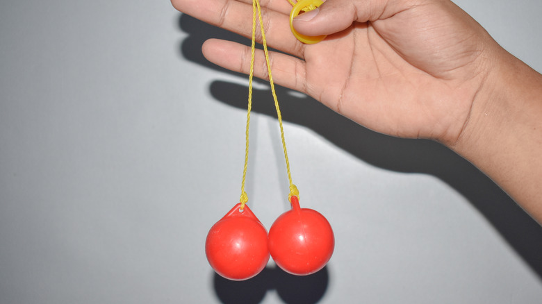 Hand dangling clackers toy