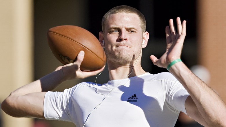 Ryan Mallett in white shirt with football