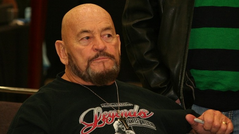 Ivan Koloff bald goatee sat holding pen
